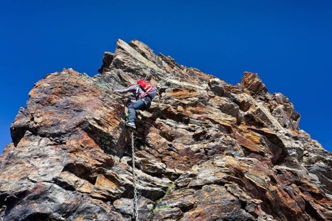 Mountain climber during the ascent of Schneebiger Nock Mountain on a climbing route in the Rieserferner Group in the Puster Valley