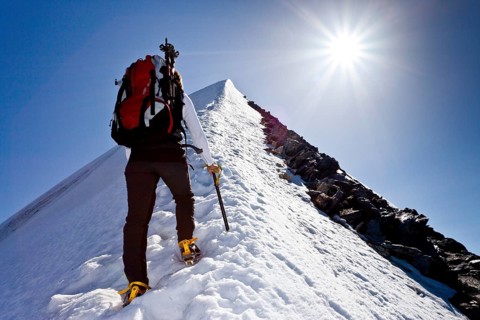 Mountain climber ascending Hochfeiler Mountain along the summit ridge