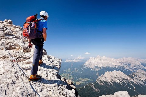 Mountain climber ascending the Via Ferrata Marino Bianchi climbing route on Monte Cristallo