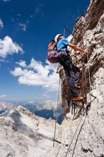 Mountain climber ascending the Via Ferrata Ivano Dibona climbing route on Monte Cristallo