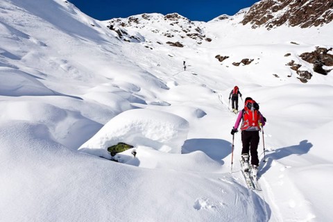 Cross country skiers ascending Wurzer Alpenspitz Mountain in the Ridnauntal Valley above Entholz