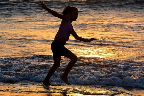 Girl playing on the beach