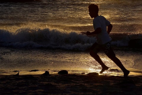 Man jogging along a beach