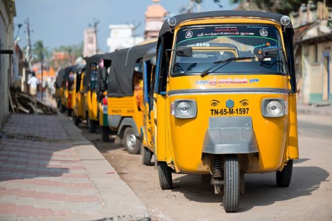 Row of yellow rickshaw taxis