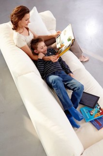 Mother and son reading on a sofa