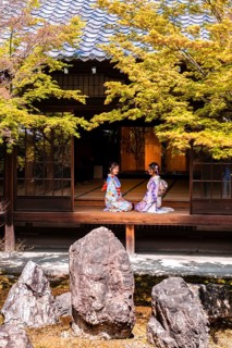 Two Japanese women dressed with kimono sitting in the courtyard of O-shoin