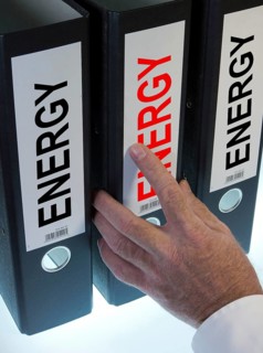 Hand reaching for a ring binder labeled Energy