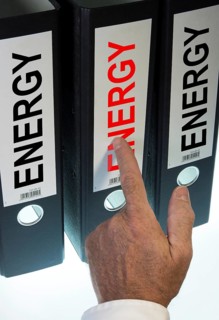 Hand pointing to a ring binder labeled Energy