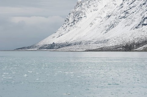 Snow-covered rocks surrounding Magdalene Fjord