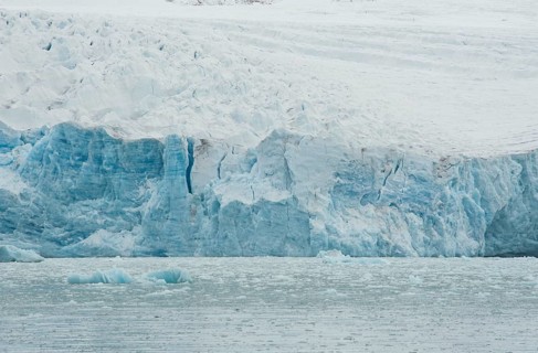 Ice avalanche into the water of a fjord