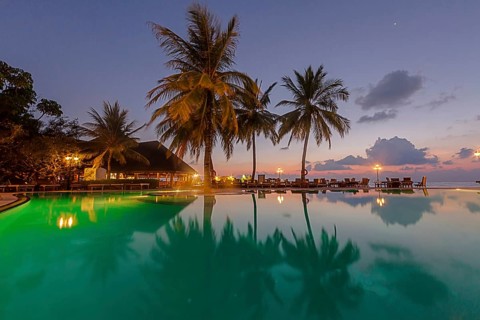 Restaurant and pool area of Paradise Island at dusk