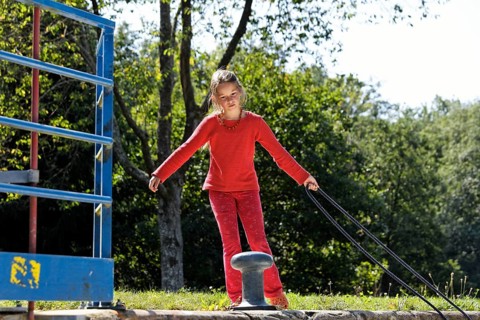 Girl fastening a rope to secure the boat in the lock chamber