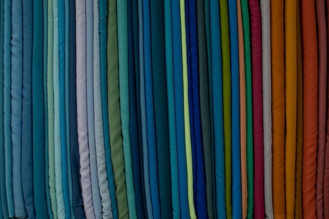 Fabrics lined up on a rack