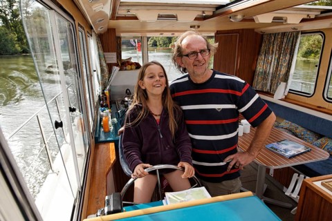 Father and daughter at the wheel of a Penichette