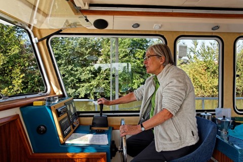 Woman at the wheel of a Penichette