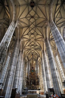 Vaulted ceiling and chancel of the late-gothic three-naved hall church