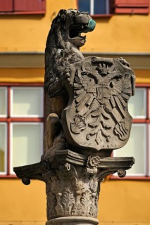 Lion sculpture holding a shield with the double-headed eagle at Loewenbrunnen