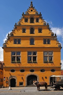 Former municipal granary with a steep pitched roof and Baroque voluted gable