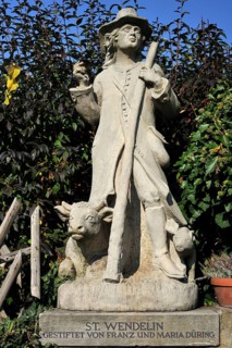 Sculpture of the shepherd St. Wendelin with a cow and pig