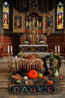 Thanksgiving decoration in front of the polyptych altar in the neo-Gothic Parish Church of St. Pelagius