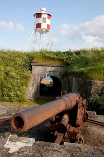 An old cannon and a beacon at Trekroner Sofort or Three Crowns Sea Fortress