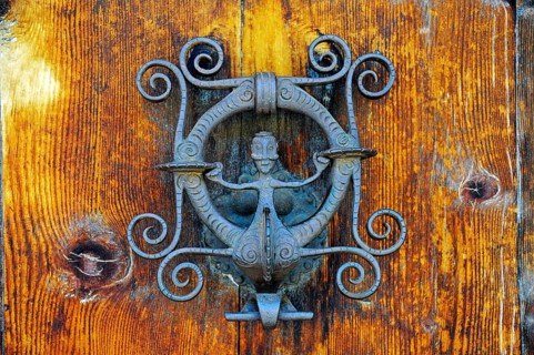 Wrought-iron door knocker with a figure