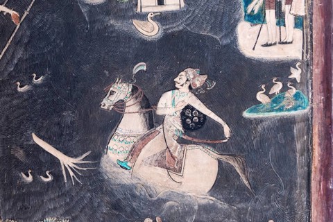Rider on horseback crossing a river