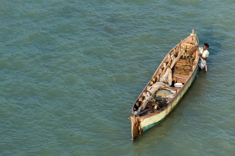 Fisherman with his fishing boat