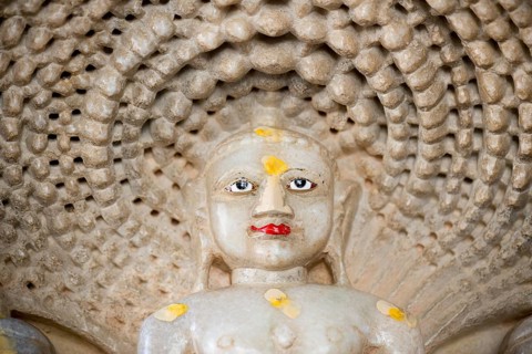 Head of Tirthankar Parshvanat in the medallion protected by the thousand-headed serpent God Dharanendra against a powerful storm