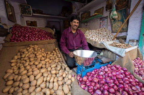 Potato and onion trader at his market stand