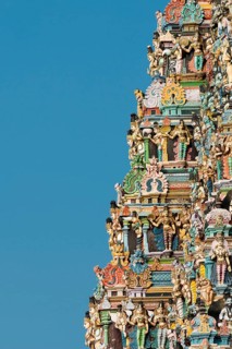 Colourful statues of gods and demons on the Gopuram or Gopura gate tower