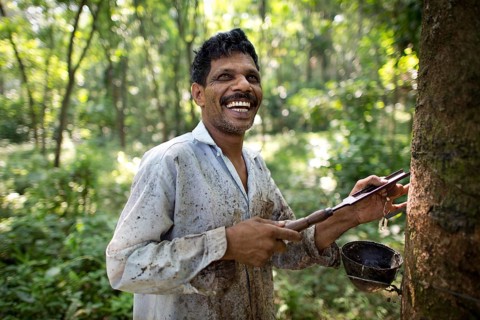 Smiling worker on a natural rubber plantation