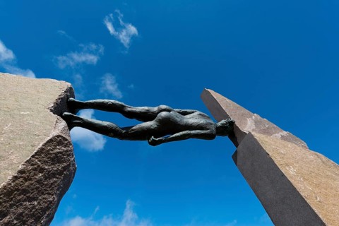 Bronze sculpture of a woman between two stones