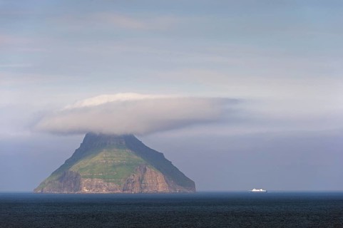 The only uninhabited island of the Faroe Islands with a ferry of the Smyril Line travelling in the Suouroyarfjorour Strait