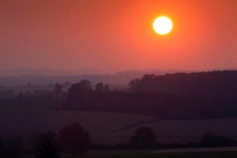 Sunset over a wooded landscape