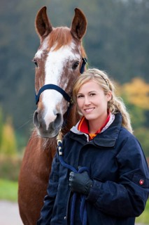 Young woman with an Austrian Warmblood