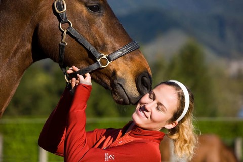 Young woman cuddling an Austrian Warmblood
