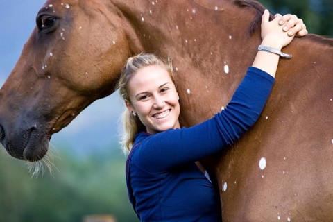 Young woman hugging a Hanoverian