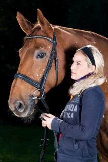 Young woman with a bridled Hanoverian