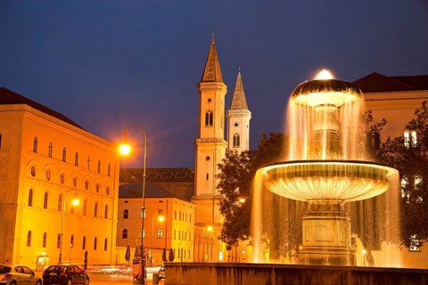 Illuminated fountain of the University and the Church of St. Louis