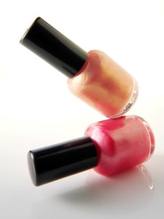 Two nail varnish bottles balanced on each other