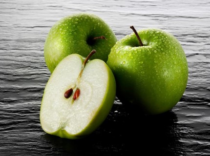Whole and cut Granny Smith apples