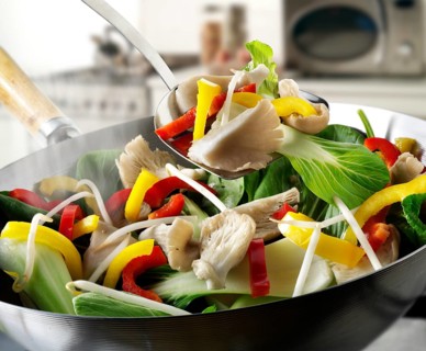 Stir-fry vegetables in a wok