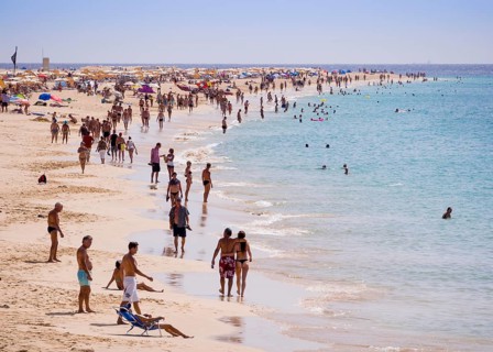 Tourists on the beach of Playa del Matorral