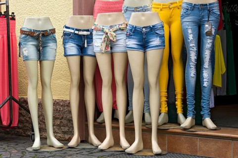 Legs of mannequins with jeans and hot pants