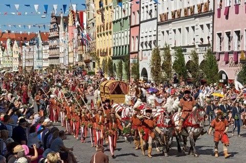Horse-drawn golden bridal carriage and escorts