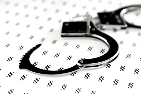 Handcuffs lying on German legal symbols