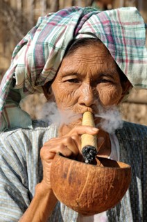 Old woman smoking a cheroot cigar