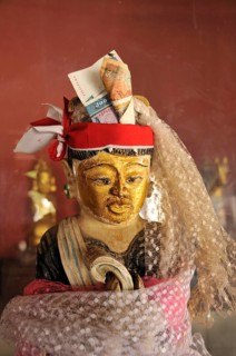 Nat character with a money offering