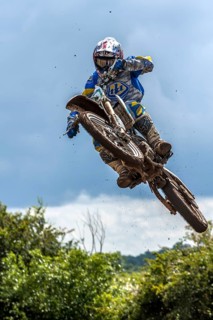 Biker on a motobike jumping at a motocross event